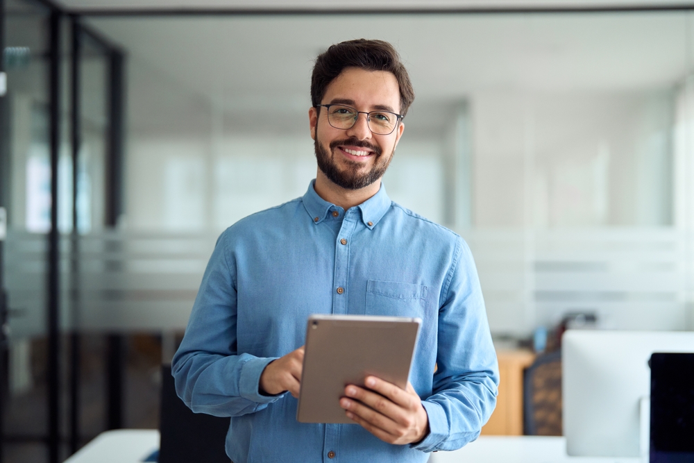 Smiling,Busy,Young,Latin,Business,Man,Manager,Using,Tablet,Computer,